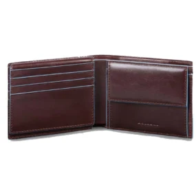 Interno aperto con scomparti porta carte di credito e tasca porta monete con patta.