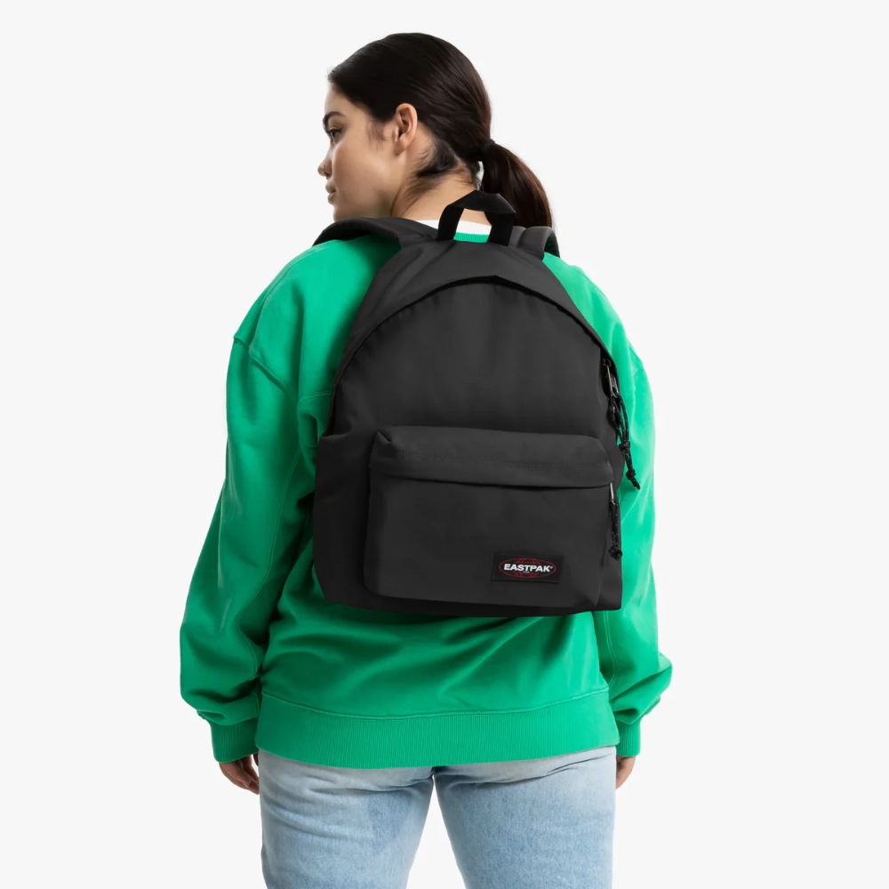Donna che indossa lo zaino nero casual a due spalle sopra una felpa verde.
