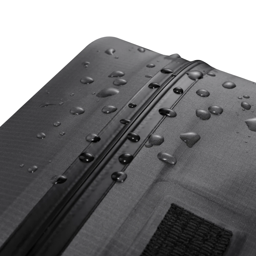 Gocce d'acqua sul tessuto tecnico e sulla zip impermeabile che dimostrano l'idrorepellenza.